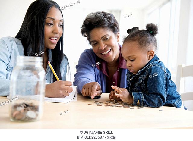 Black multi-generation family counting coins