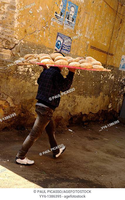 early morning bread delivery , backstreets of islamic cairo , egypt