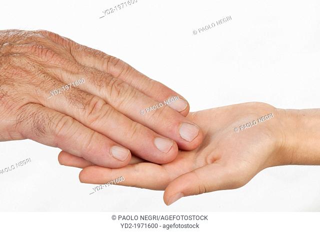 child's hand open with the hand of man over