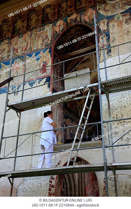 Conservator at work on the frescoes. The Moldovita Monastery is a Romanian Orthodox monastery situated in the commune of Vatra Moldovitei, Suceava County