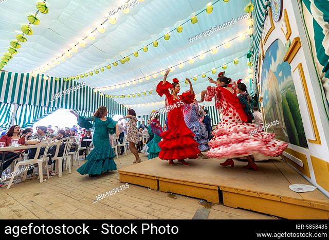 Young woman dancing Sevillano, Spanish woman with flamenco dresses in colourful marquee, Casetas, Feria de Abril, Sevilla, Andalusia, Spain, Europe
