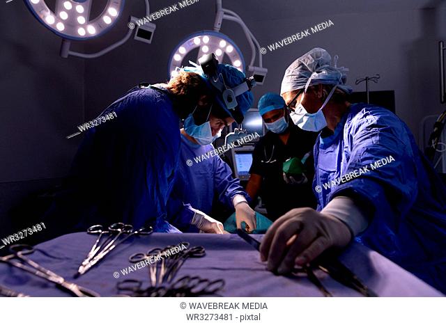 Surgeons performing operation in operating room at hospital