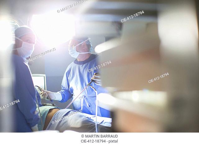 Doctors performing laparoscopic surgery in operating theater