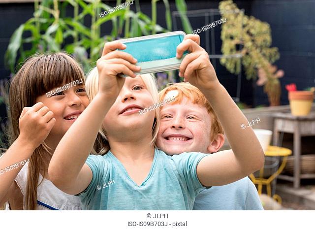Smiling children taking selfie