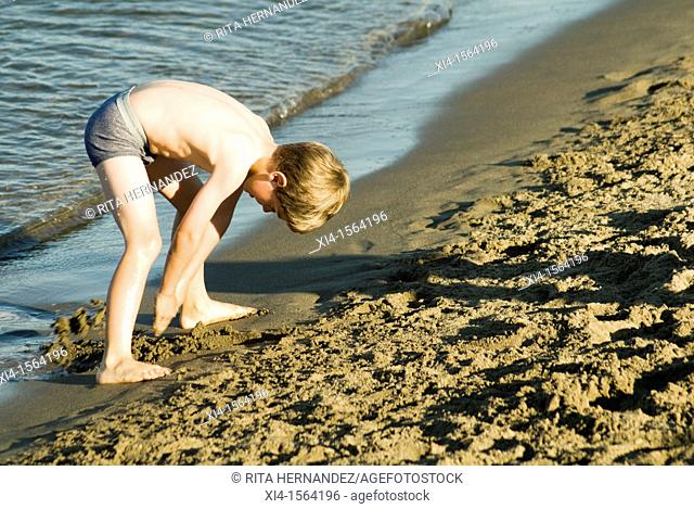 Child playing with sand at the Beach. Jerico Beach in Vancouver, British Columbia in Canada
