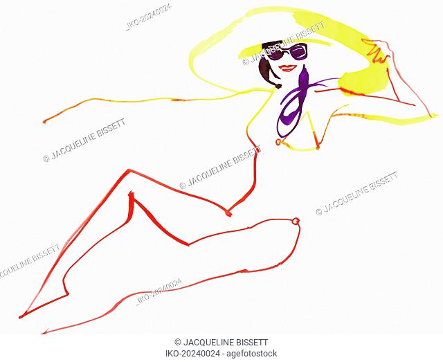 Beautiful woman reclining in sunglasses and sun hat