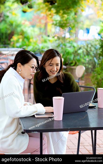 Two women having meeting in open space office