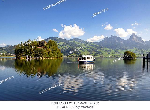 Lauerzersee with Schwanau Island and tourist boat, behind small and Grosse Mythe, Lauerz, Canton of Schwyz, Switzerland