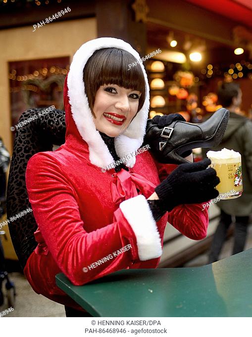 Contortionist Alina Ruppel drinking egg punch at the Christmas market in Cologne, Germany, 12 December 2016. Ruppel is due to compete in the final of RTL talent...