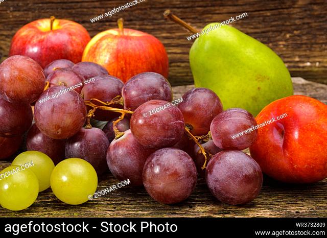 arrangement of fresh fruits from market over wooden planks