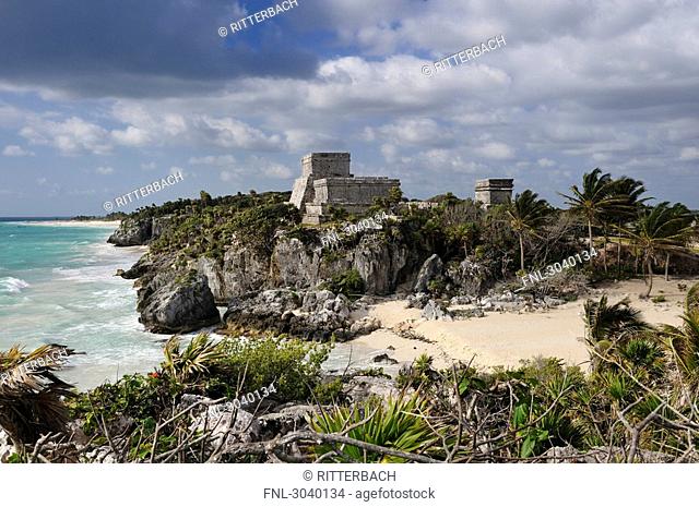 View over beach to complex of buildings of the Maya ruin site of Tulum, Riviera Maya, Mexico