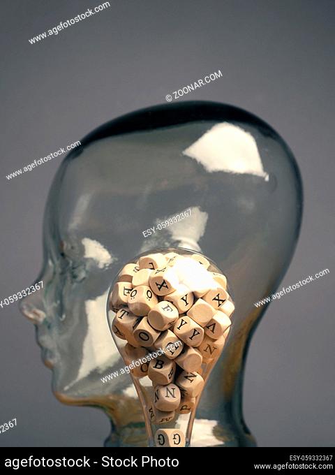 A lot of alphabetically labeled wooden cubes in a light bulb, creativity or educational concept