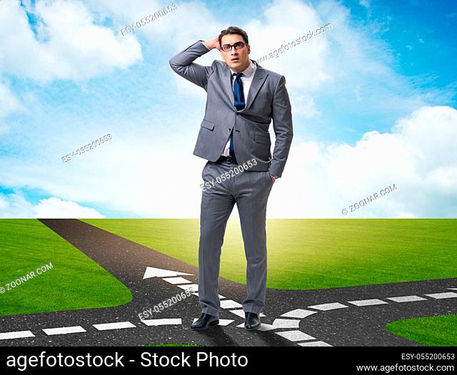 The young businessman at crossroads in uncertainty concept