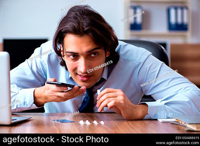 The young man having problems with narcotics at workplace