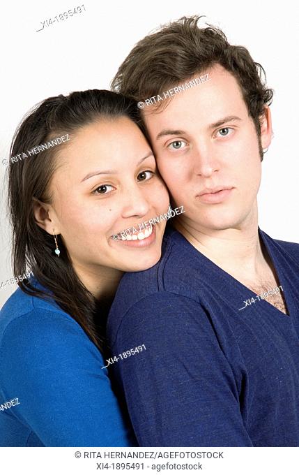 Multicultural couple portrait hugging  White background