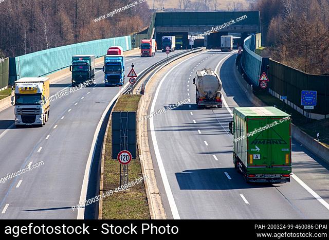24 March 2020, Saxony, Breitenau: Trucks drive along the BAB17 near Breitenau. Commuters in the border area have to go into a fortnightly quarantine from 26