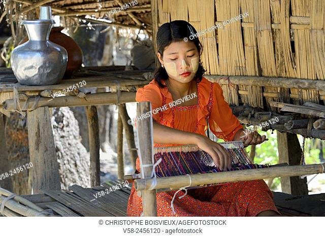 Myanmar, Rakhine State, Mrauk U region, Pan Ba village, Young Chin girl weaving a cotton scarf