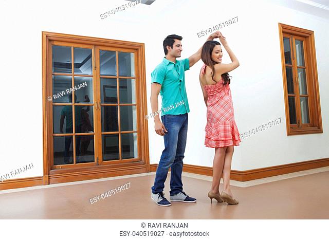 Young man and young woman dancing