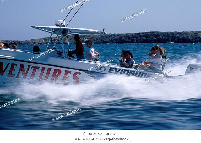 Fast speed boat with white wake. Group of people