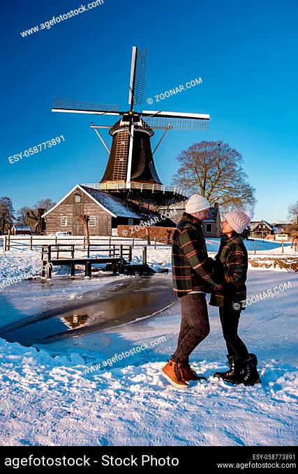 Pelmolen Ter Horst, Rijssen covered in a snowy landscape Overijssel Netherlands, historical wind mill during winter. wooden old windmill in Holland