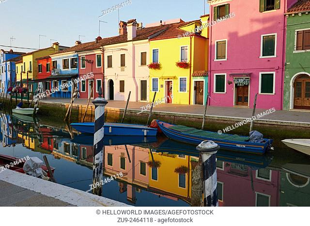 Brightly painted Burano houses reflected in a canal, Venetian Lagoon, Veneto, Italy, Europe