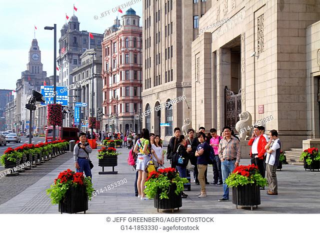 China, Shanghai, Huangpu District, The Bund, Zhongshan Road, Art Deco Neo Classical style buildings, historic, Asian, man, woman, planter box, poinsettia