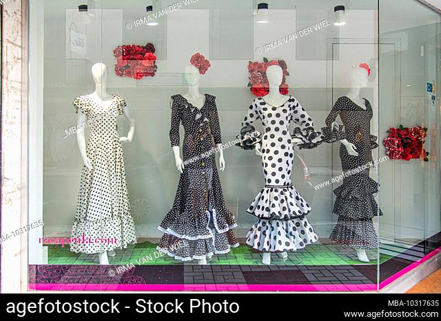 One day in Malaga; Impressions from this city in Andalusia, Spain. Flamenco dresses in the window of a fashion store