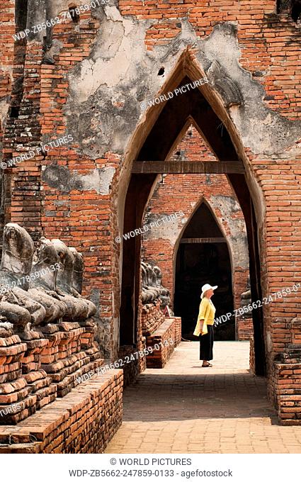 Woman visitor at Wat Chaiwatthanaram Buddhist temple ruins in Ayutthaya, Thailand