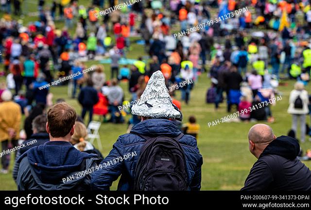 07 June 2020, Baden-Wuerttemberg, Leonberg: One participant wears an aluminium hat at a demonstration of the initiative ""Querdenken 711""