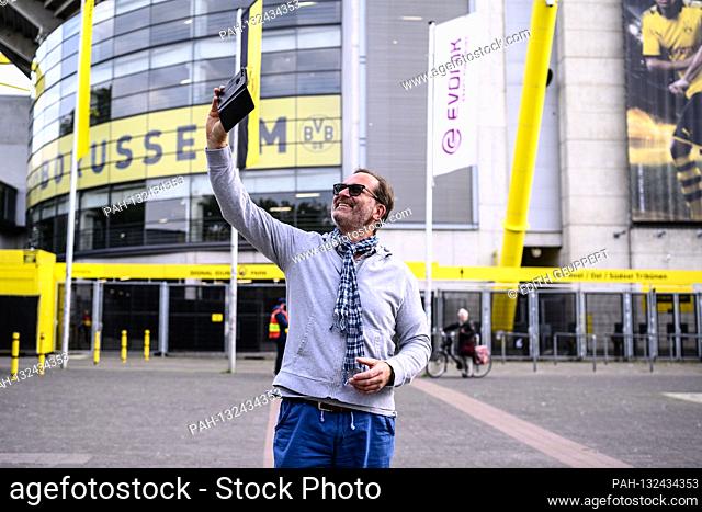 A fan takes a selfie in front of the stadium during the game. GES / Football / 1st Bundesliga: Borussia Dortmund - FC Schalke 04, May 16