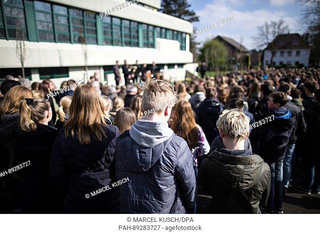 Students stand in front of a memorial plaque during a commemoration at the Joseph Koenig secondary school in Haltern am See, Germany, 24 March 2017