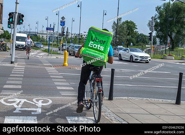 WARSAW, POLNAD - June 15, 2019: UberEATS cycle delivery courier. Uber Eats delivery in progress on Warsaw street - Poland