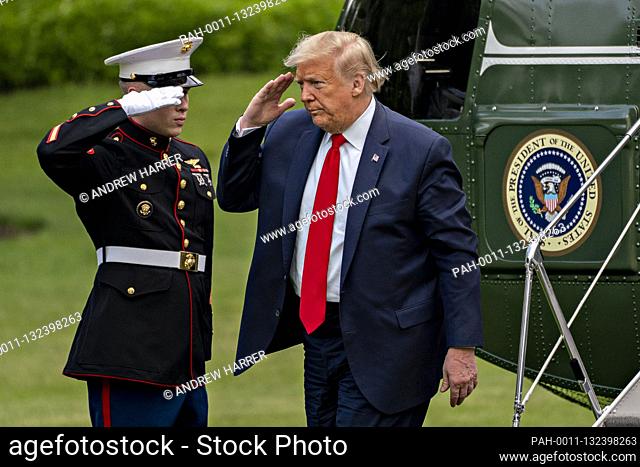 United States President Donald J. Trump salutes the Marine Guard after exiting Marine One on the South Lawn of the White House in Washington, D.C., U