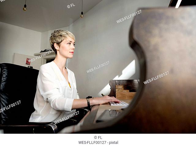 Blond woman working at home office