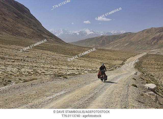 Bicyclist crossing the Khargush Pass on the Pamir Highway, Tajikistan