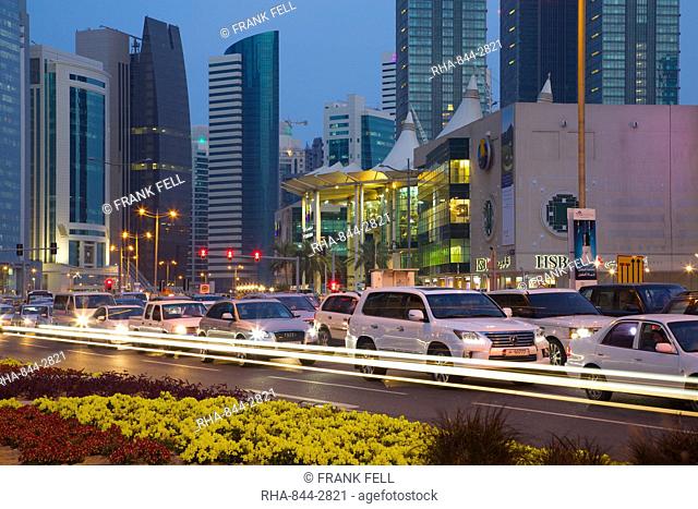 Contemporary architecture and traffic at dusk in the City Centre, Doha, Qatar, Middle East