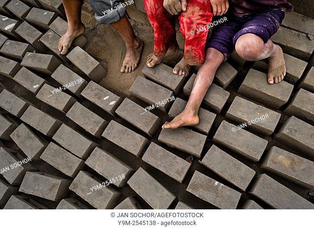 Peruvian children take a rest while working at a brick factory in Huachipa, a suburb in the outskirts of Lima, Peru, 10 August 2012