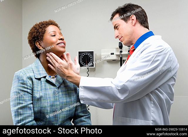 Doctor checking womans throat