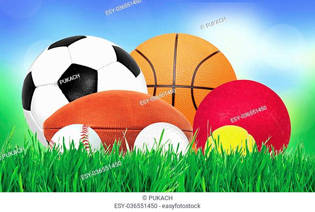 Sports balls over green grass over nature background