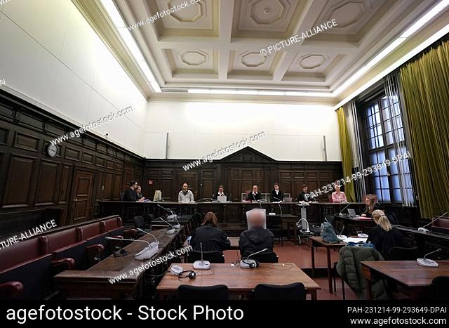 14 December 2023, Hamburg: The defendant (front M) sits in the courtroom in the criminal justice building next to his lawyer at the start of the trial for...