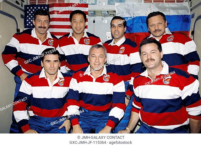 Five astronauts and two cosmonauts pose for the STS-106 version of the traditional inflight crew portrait. Though the tradition is long standing