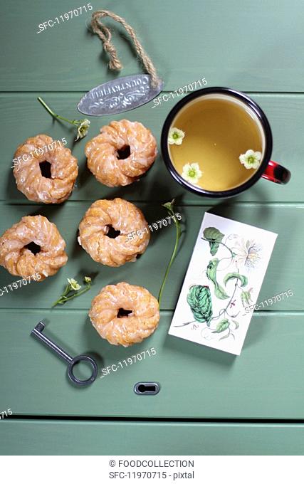 Glazed, deep-fried pastry rings with a cup of tea