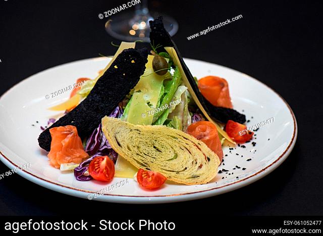 Caesar salad with salmon fish. Tasty restaurant dish