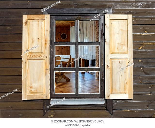 Rustic style window in wooden village home. Contains galss clipping patch. The room can be easily replaced with another background