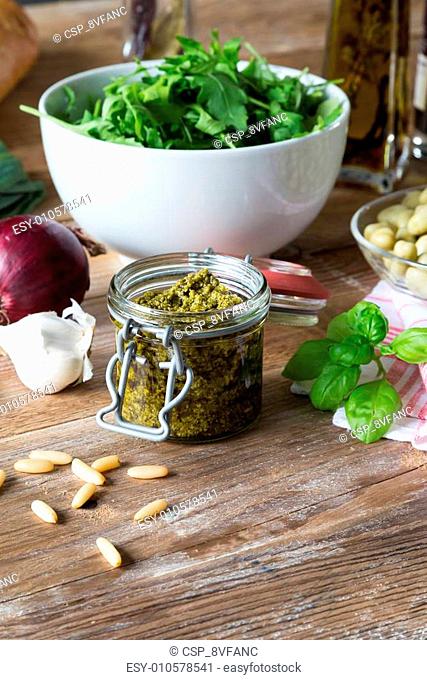 Pesto in a jar with ingredients