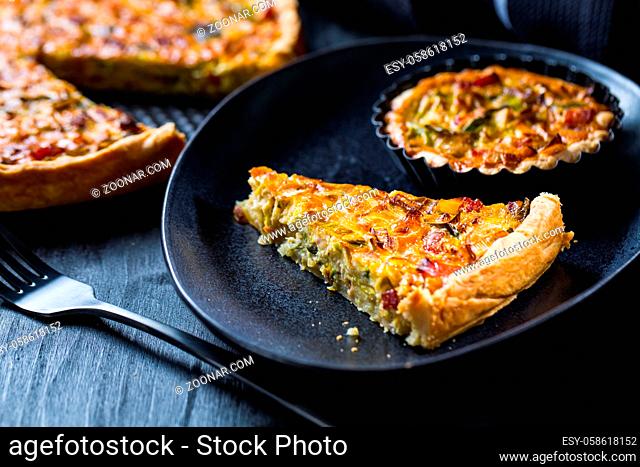 Quiche Lorraine - traditional French tart with pastry crust filled with bacon and leek