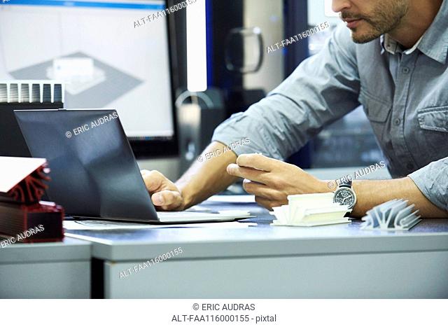 Engineer using laptop in office