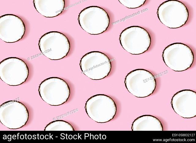 Coconut pattern on the pink background. Set of coconut halves. High quality photo