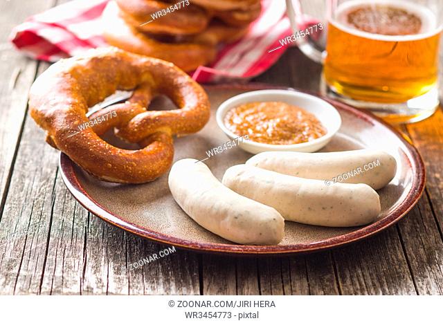 The bavarian weisswurst, pretzel and mustard on plate