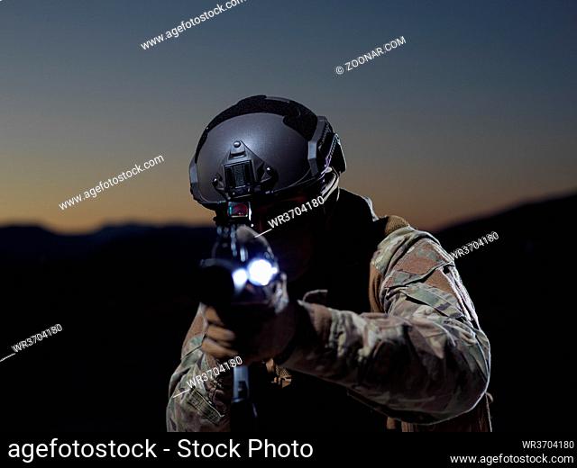 soldier with weapon and full military equioment and combat gear in night mission